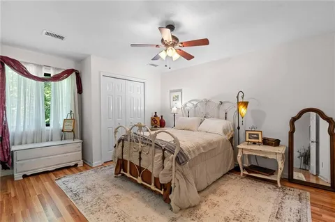 a bedroom with a bed and wooden floor