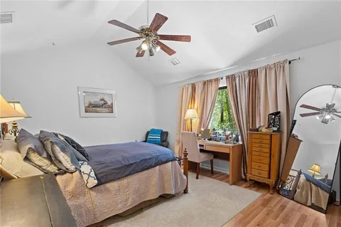 a view of a bedroom with window and tub