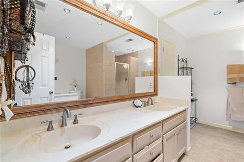 a bathroom with a tub sink and mirror