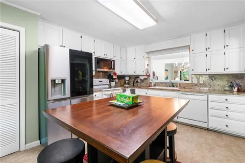 a kitchen with a table and chairs in it