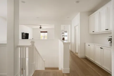 a view of a kitchen with furniture and wooden floor