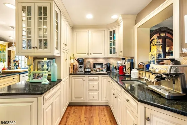 a large kitchen with stainless steel appliances granite countertop a sink and cabinets