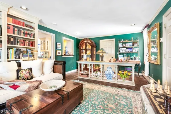a living room with furniture and a book shelf