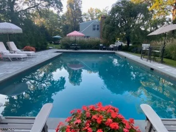 a front view of a house with swimming pool garden and patio