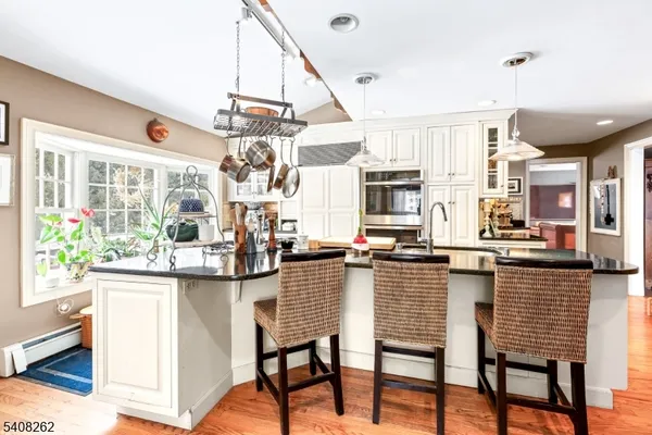 a dining table chairs and a kitchen view