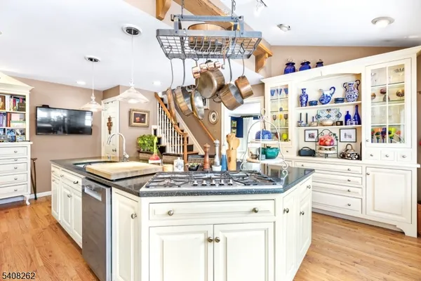 a kitchen with stainless steel appliances granite countertop a stove and a sink