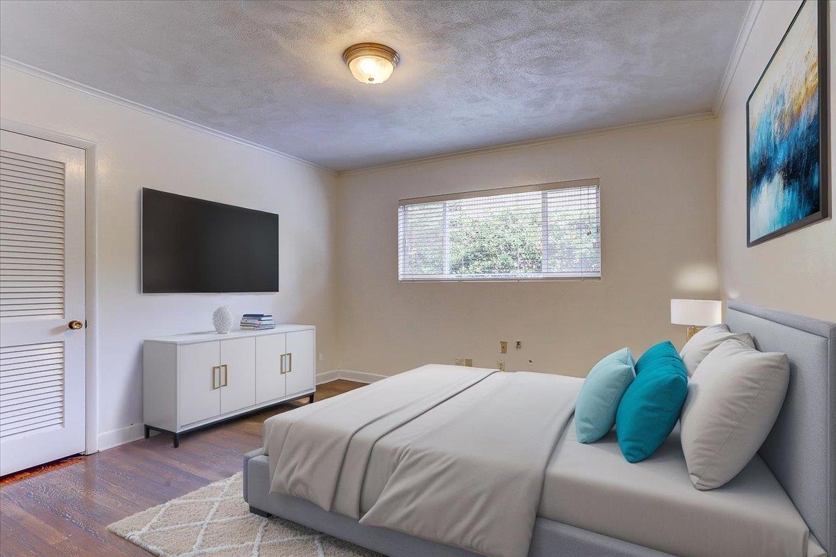 5680 North Angela Road Memphis, TN 38120 - Photo 11 of 33 Bedroom featuring ornamental molding, wood finished floors, and a textured ceiling
