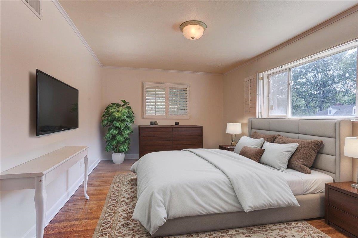 5680 North Angela Road Memphis, TN 38120 - Photo 12 of 33 Bedroom featuring wood finished floors and crown molding