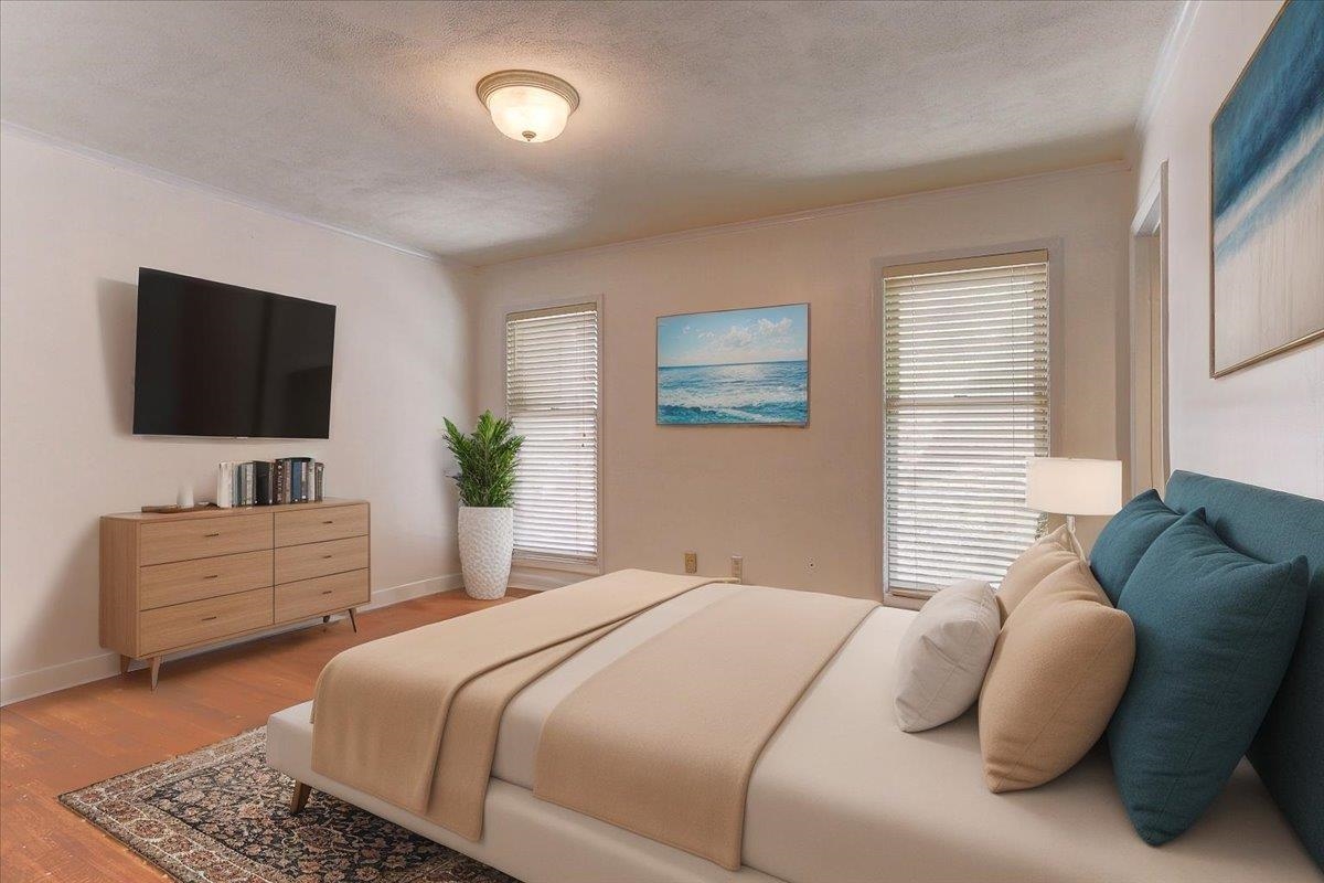 5680 North Angela Road Memphis, TN 38120 - Photo 15 of 33 Bedroom featuring wood finished floors, a textured ceiling, and ornamental molding