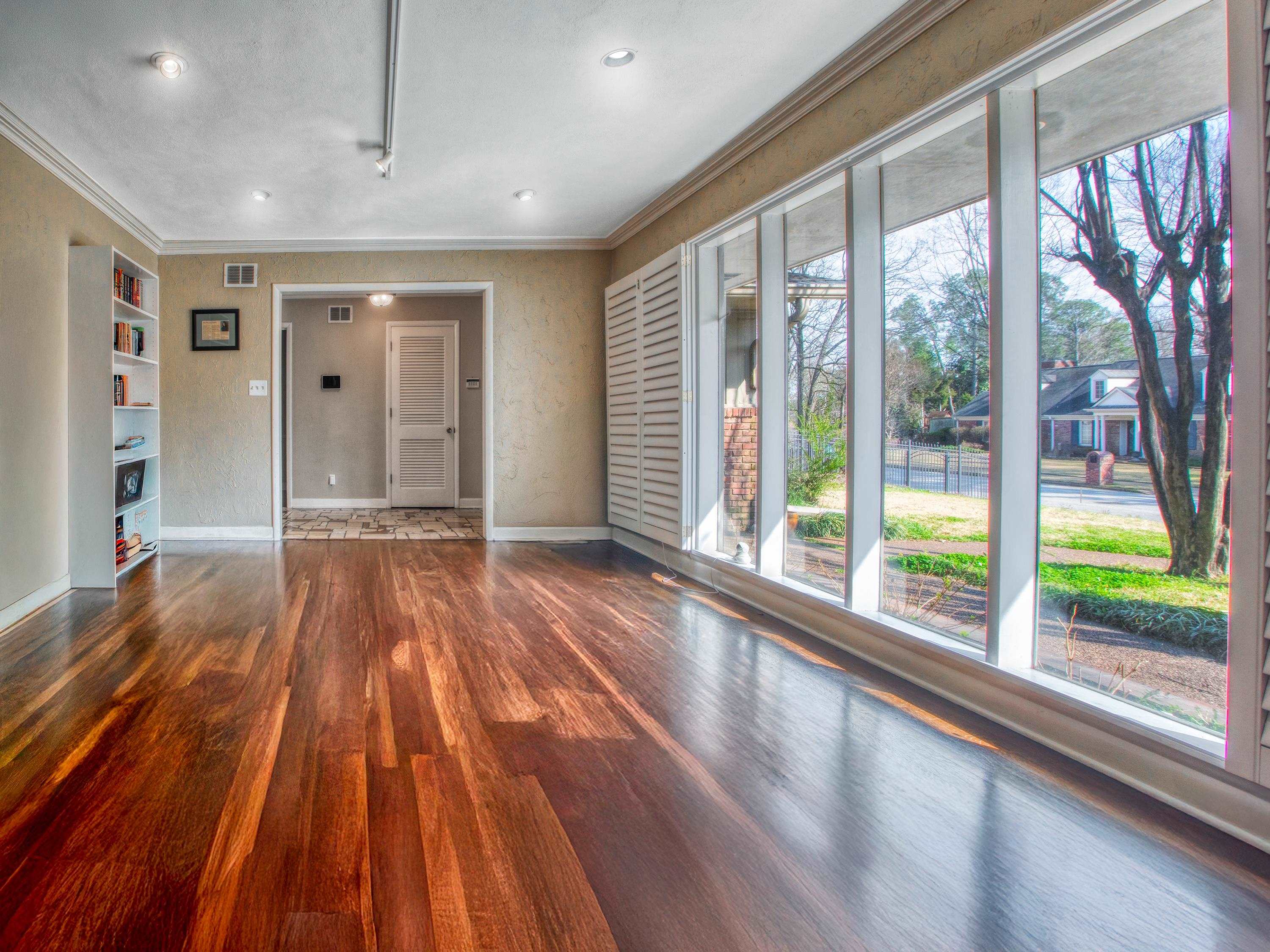 5680 North Angela Road Memphis, TN 38120 - Photo 3 of 33 Unfurnished living room with dark wood finished floors and ornamental molding