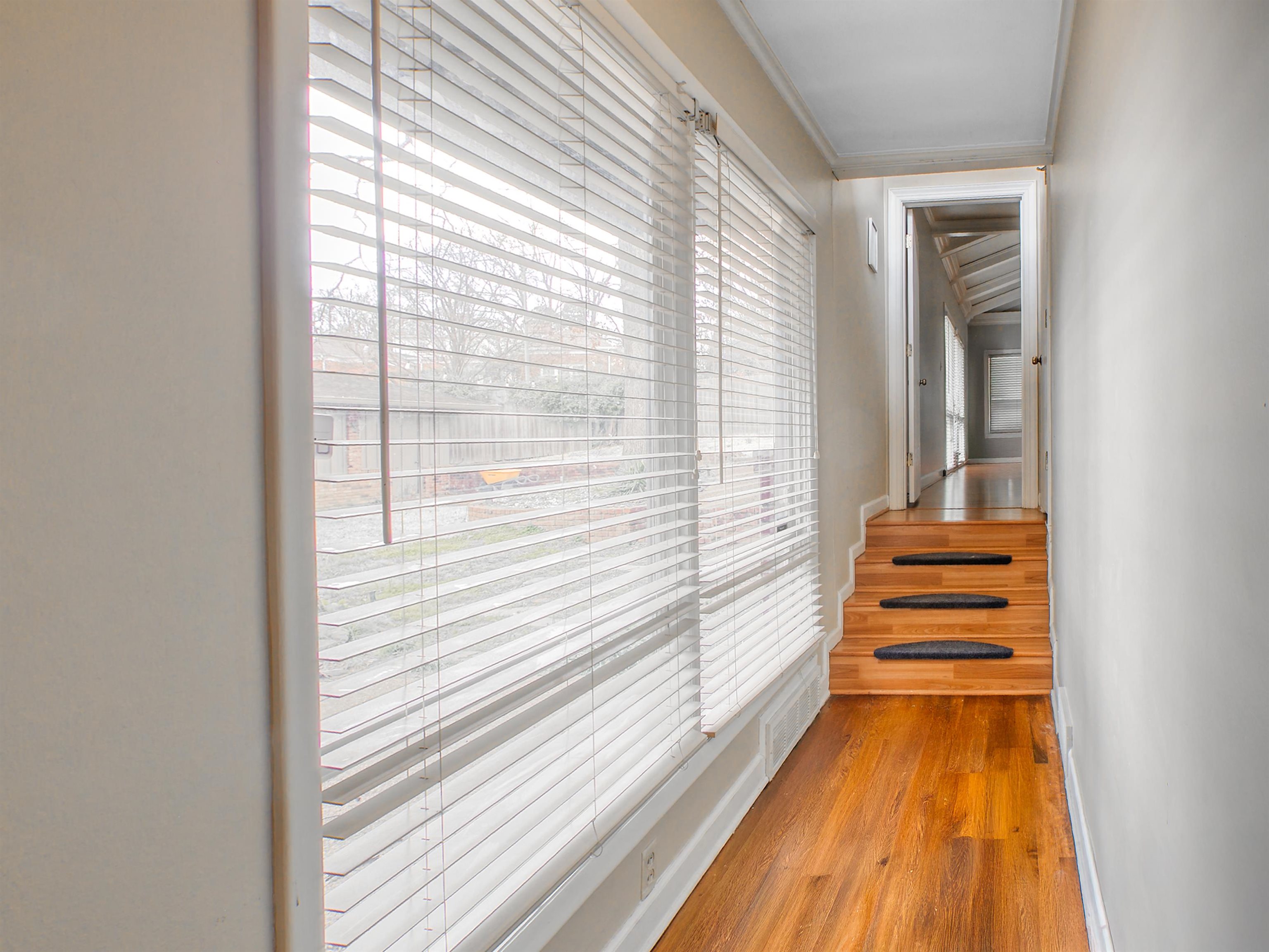5680 North Angela Road Memphis, TN 38120 - Photo 8 of 33 Hallway featuring wood finished floors and crown molding