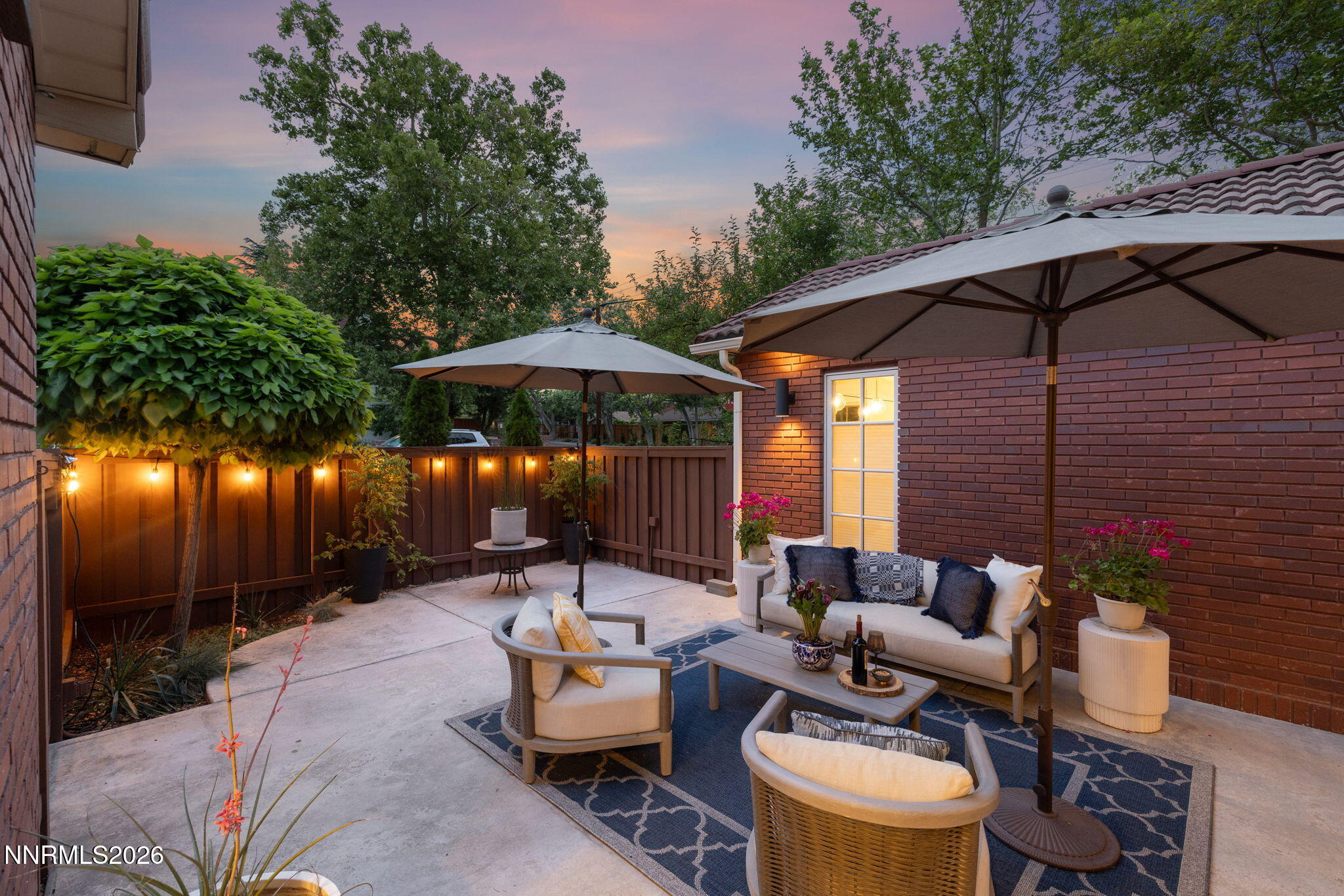 210 Bret Harte Avenue Reno, NV 89509 - Photo 15 of 40 a view of a patio with couches under an umbrella