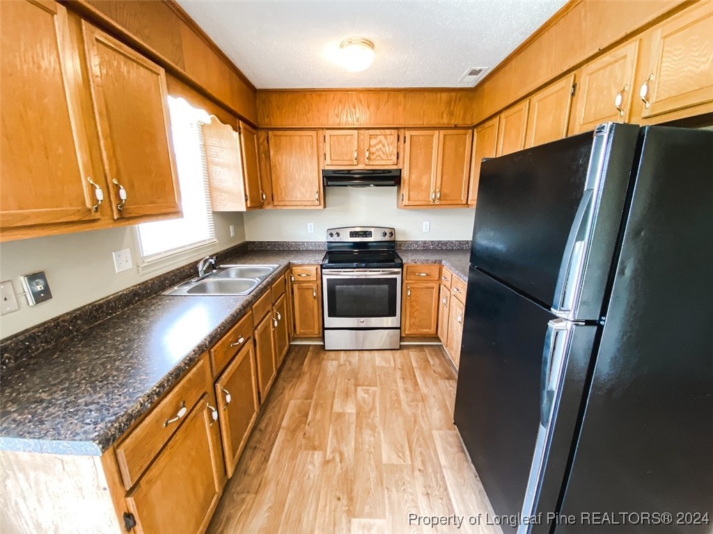 1829 Horne Camp Road, Unit 2 Fairmont, NC 28340 - Photo 7 of 18 a kitchen with stainless steel appliances granite countertop a refrigerator a stove and a sink