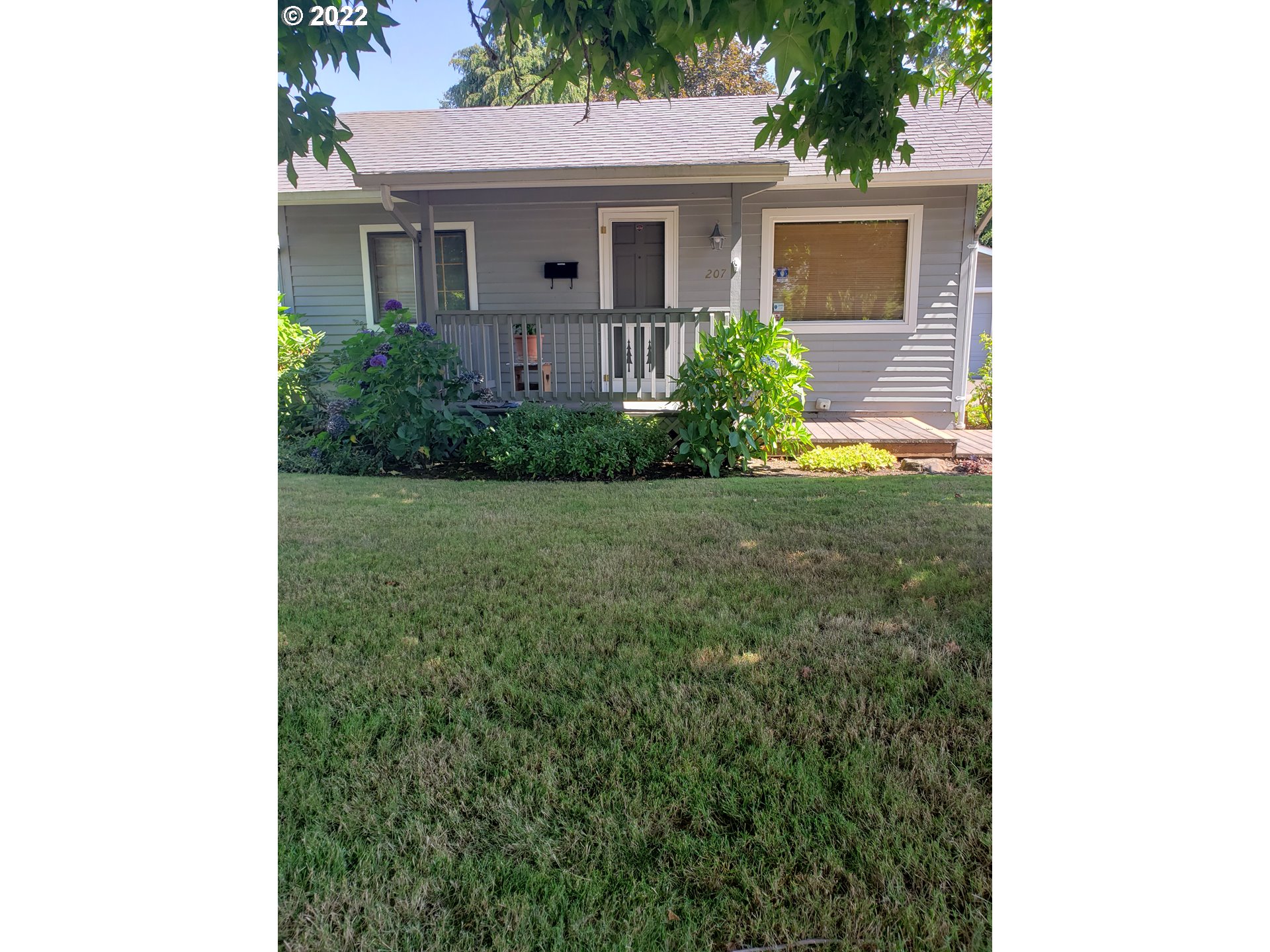 207 16th Street Springfield, OR 97477 - Photo 1 of 2 a front view of a house with garden