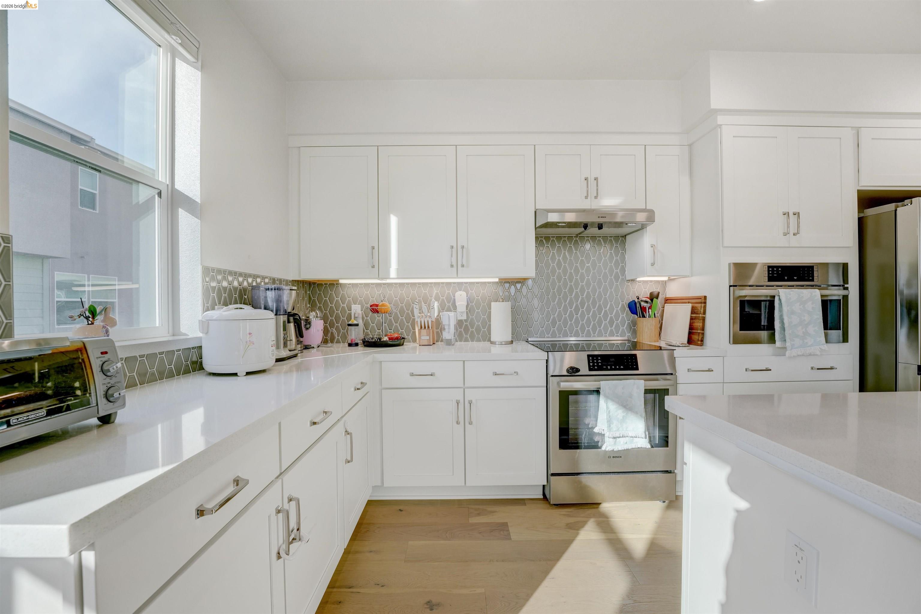 7101 Melon Court San Ramon, CA 94583 - Photo 22 of 58 a kitchen with stainless steel appliances granite countertop a refrigerator sink and white cabinets