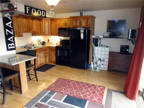 180 Evergreen Road, Unit 202E Dillon, CO 80435 - Photo 6 of 24 a kitchen with a refrigerator and a stove top oven