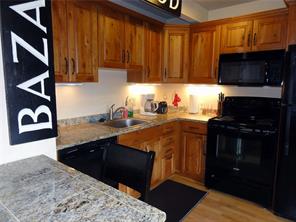 180 Evergreen Road, Unit 202E Dillon, CO 80435 - Photo 8 of 24 a kitchen with stainless steel appliances granite countertop a stove a sink and a microwave
