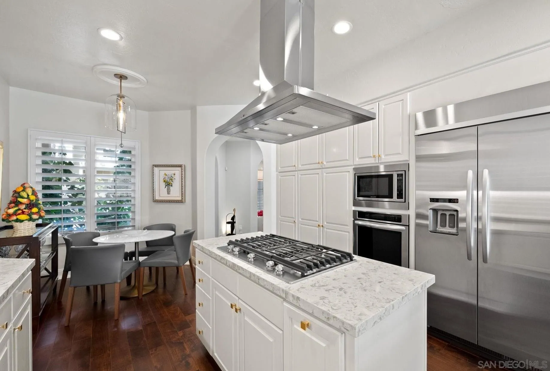 7723 Ivanhoe Avenue La Jolla, CA 92037 - Photo 12 of 35 a kitchen with a stove a refrigerator and a dining table