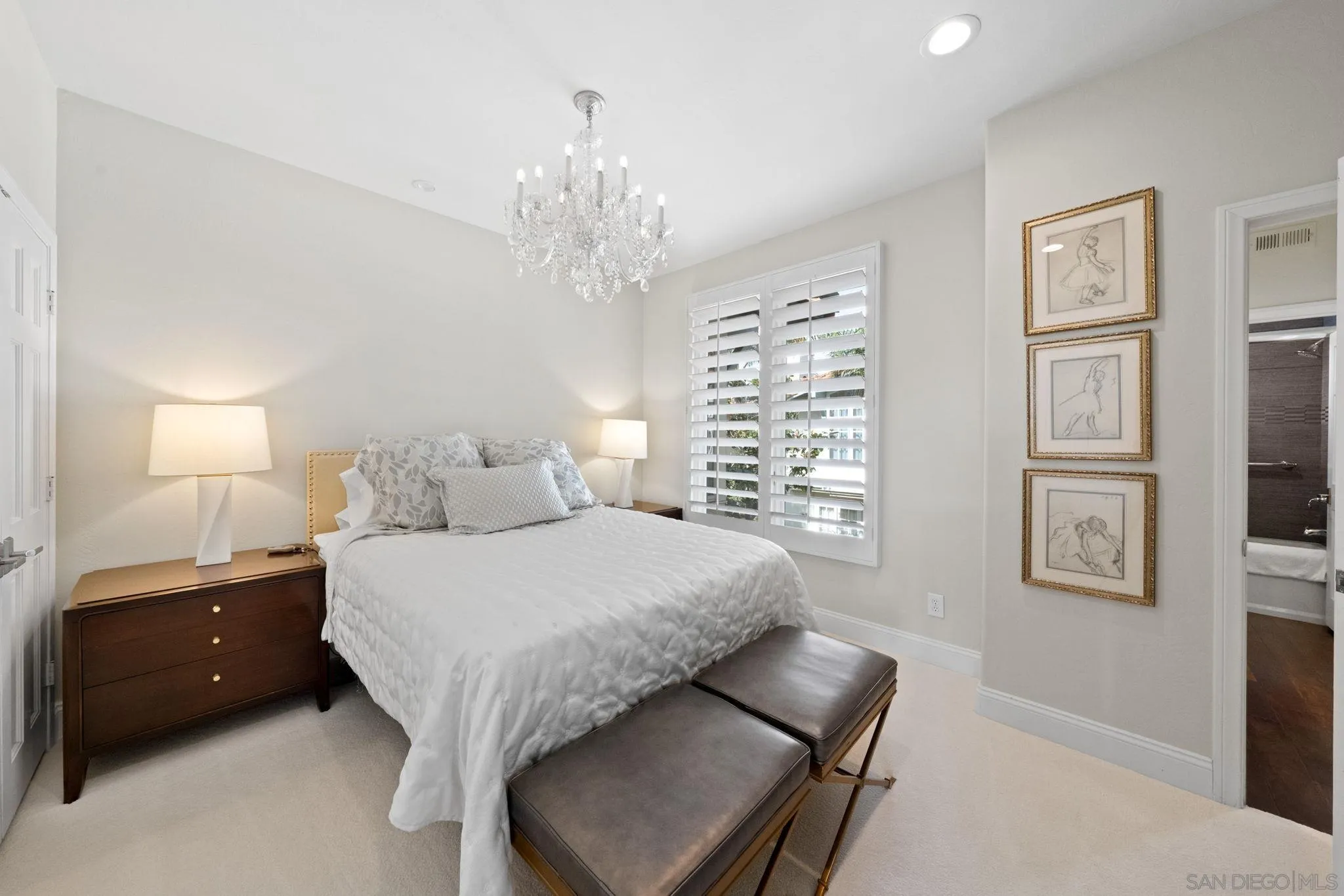 7723 Ivanhoe Avenue La Jolla, CA 92037 - Photo 21 of 35 a bedroom with a large bed and a chandelier