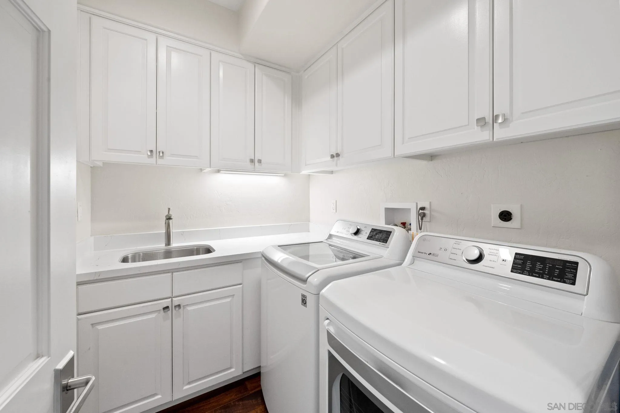 7723 Ivanhoe Avenue La Jolla, CA 92037 - Photo 24 of 35 a utility room with stainless steel appliances white cabinets and a sink