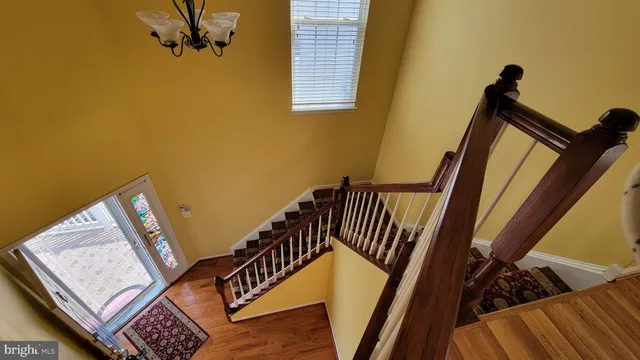 a view of hallway with wooden floor