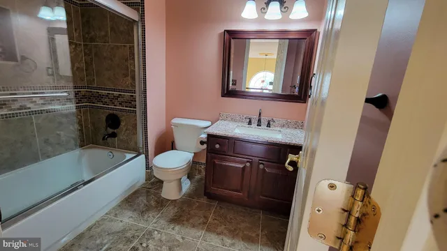 an empty room with wooden floor and closet