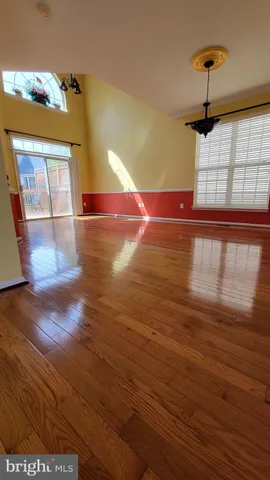 a view of a living room with hardwood floor