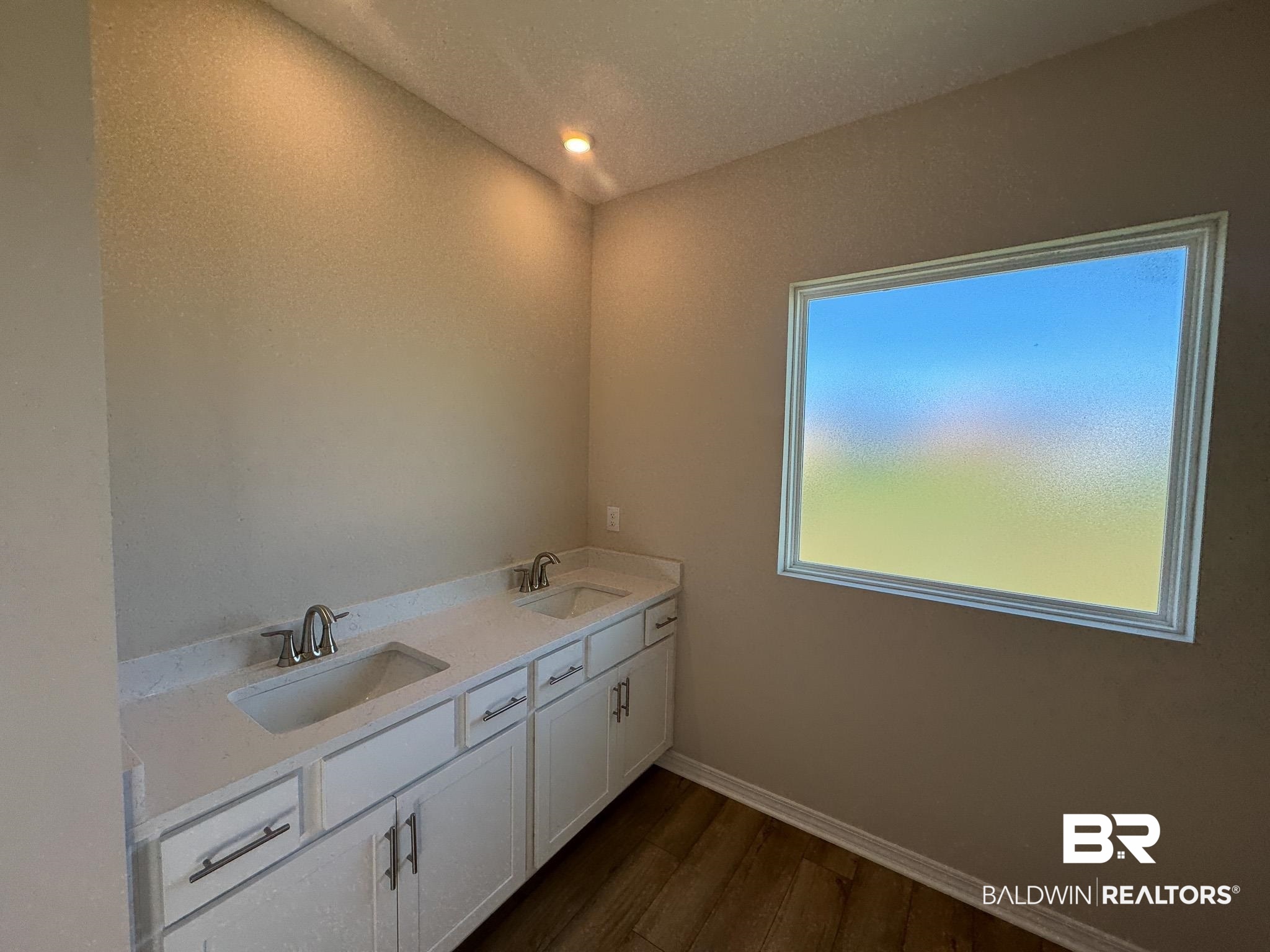 24026 Shadowridge Drive Daphne, AL 36526 - Photo 5 of 11 Bathroom featuring hardwood / wood-style floors, vanity, and lofted ceiling
