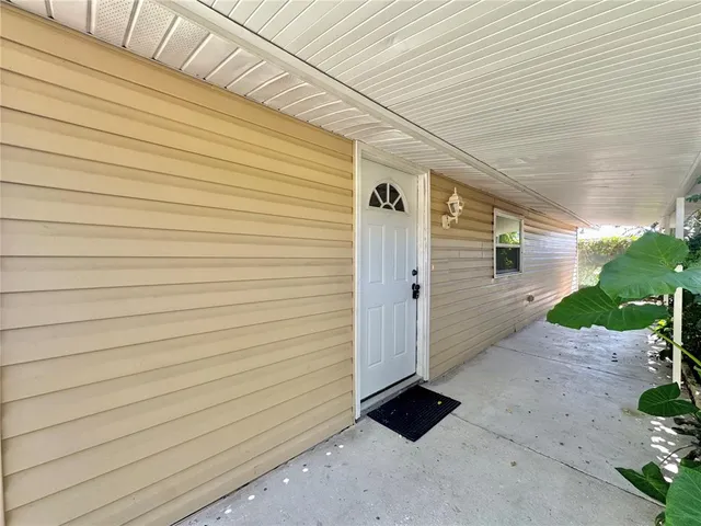 a dining hall with stainless steel appliances kitchen island granite countertop a table chairs and a refrigerator