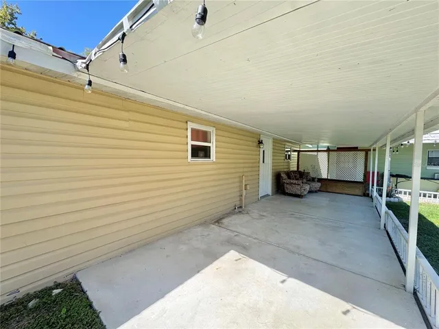 a view of a house with a yard and potted plants