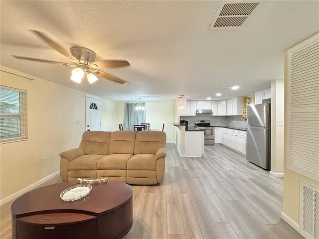 a kitchen with stainless steel appliances a refrigerator and a stove top oven