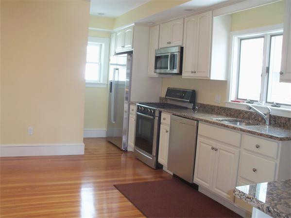 37 Cummings Road Newton, MA 02459 - Photo 3 of 26 a kitchen with granite countertop a stove a sink and a microwave
