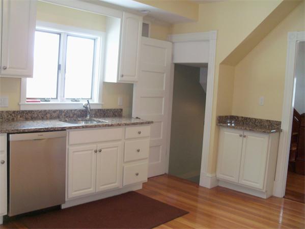 37 Cummings Road Newton, MA 02459 - Photo 4 of 26 a kitchen with granite countertop white cabinets and a sink