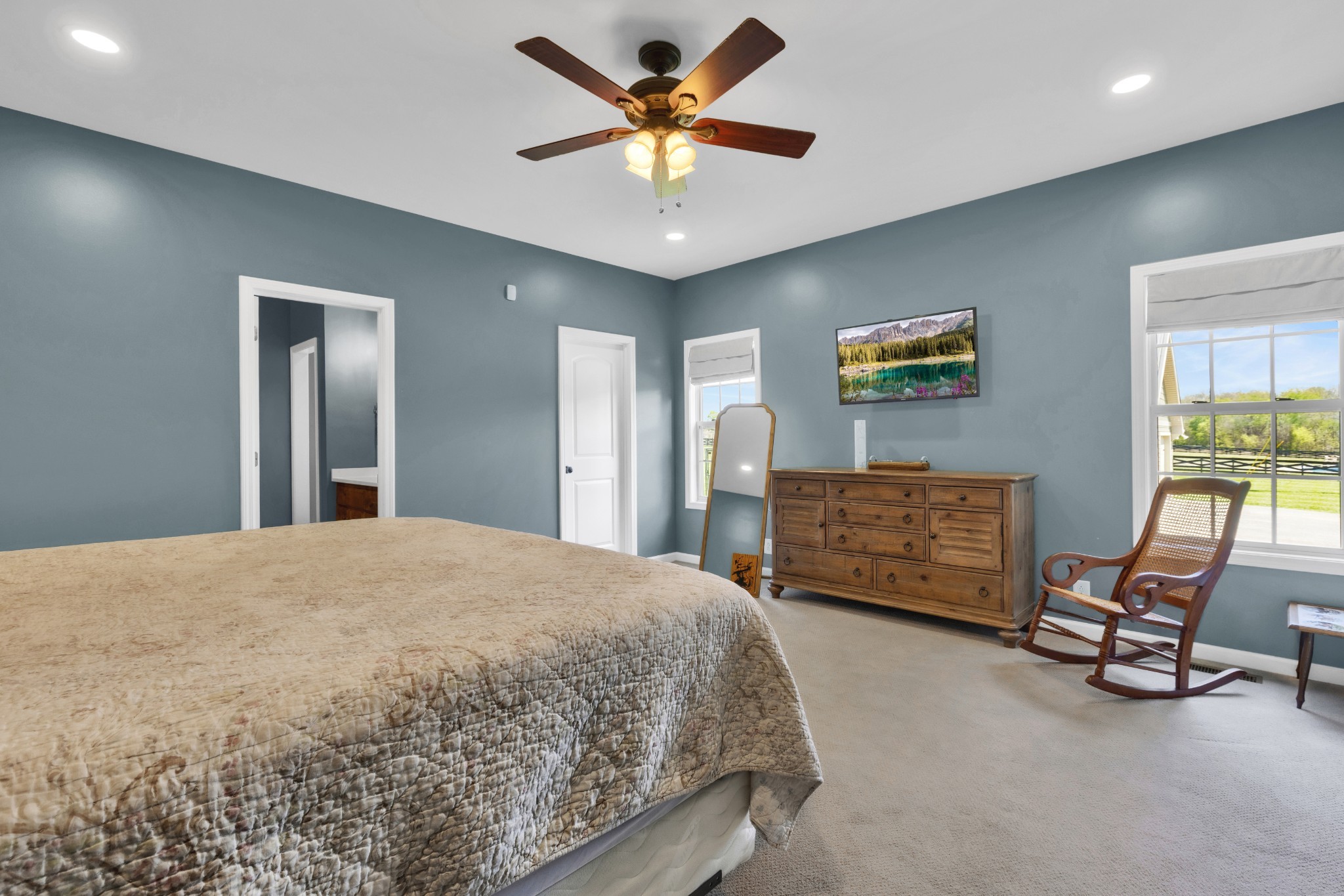 3988 Fykes Grove Road Cedar Hill, TN 37032 - Photo 23 of 50 a bedroom with a bed a chair and a chandelier