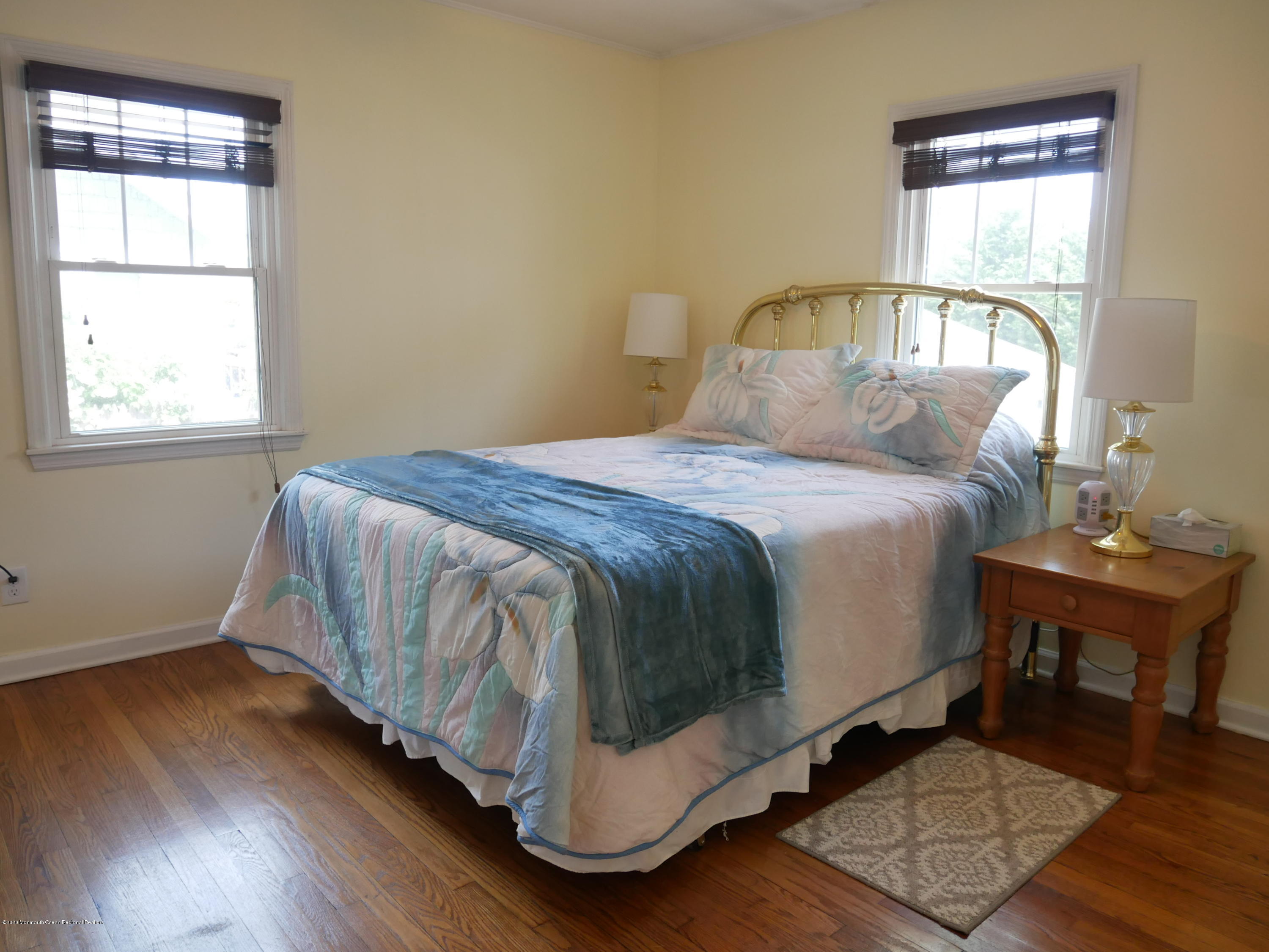 319 Arnold Avenue Point Pleasant Beach, NJ 08742 - Photo 12 of 34 a bedroom with a bed and wooden floor