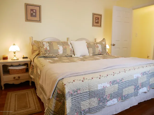 a bedroom with a bed and lamp