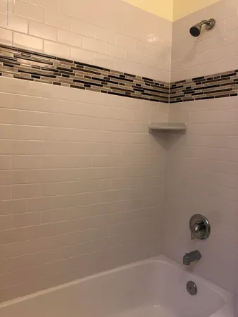 a bathroom with a shower and a sink