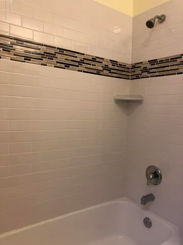 a bathroom with a shower and a sink