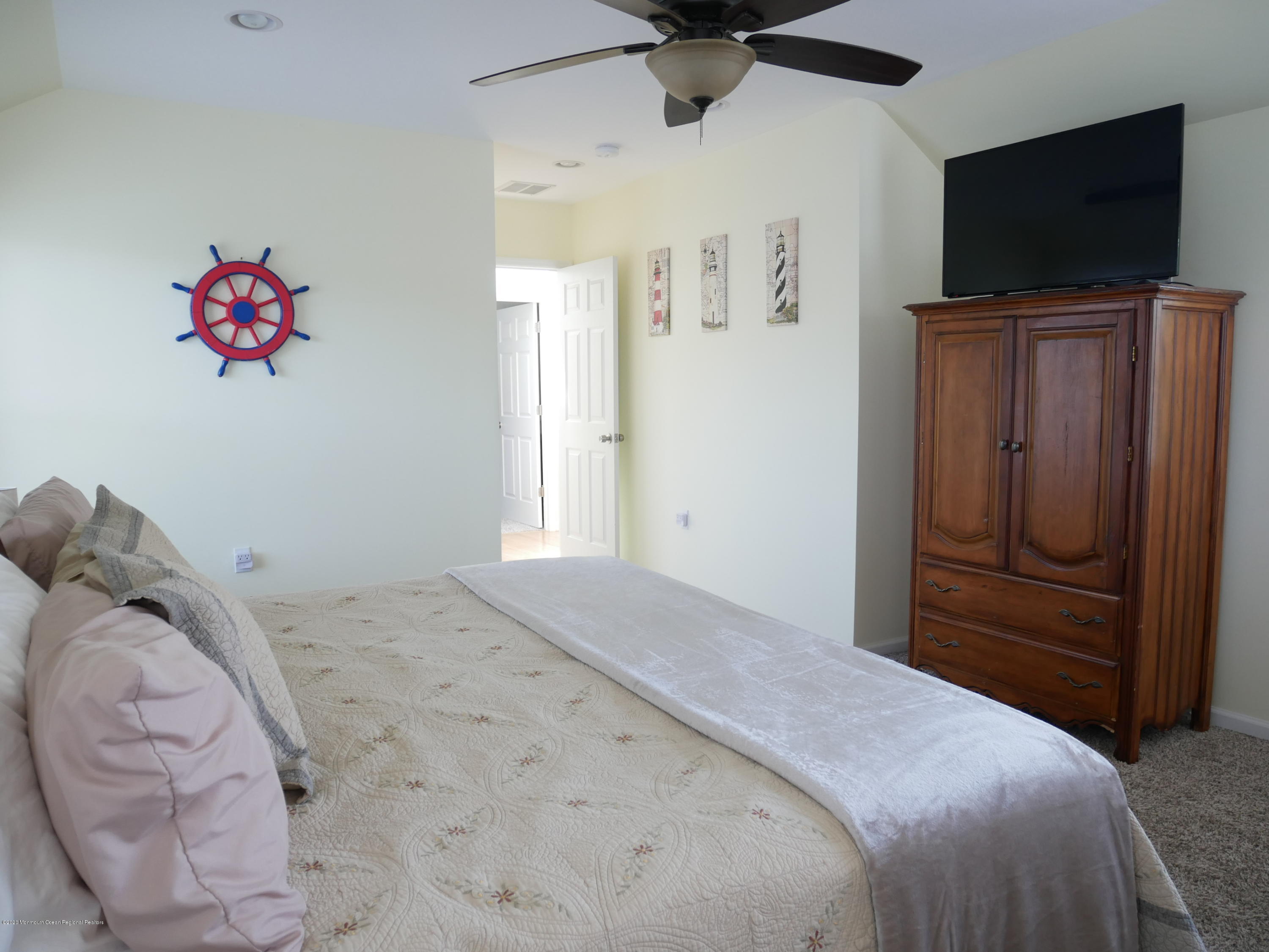 319 Arnold Avenue Point Pleasant Beach, NJ 08742 - Photo 21 of 34 a bedroom with a bed and a flat screen tv