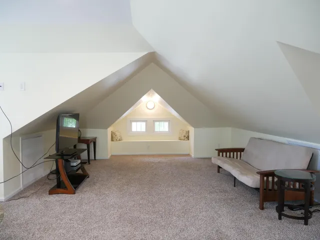 a view of a livingroom with furniture and a window