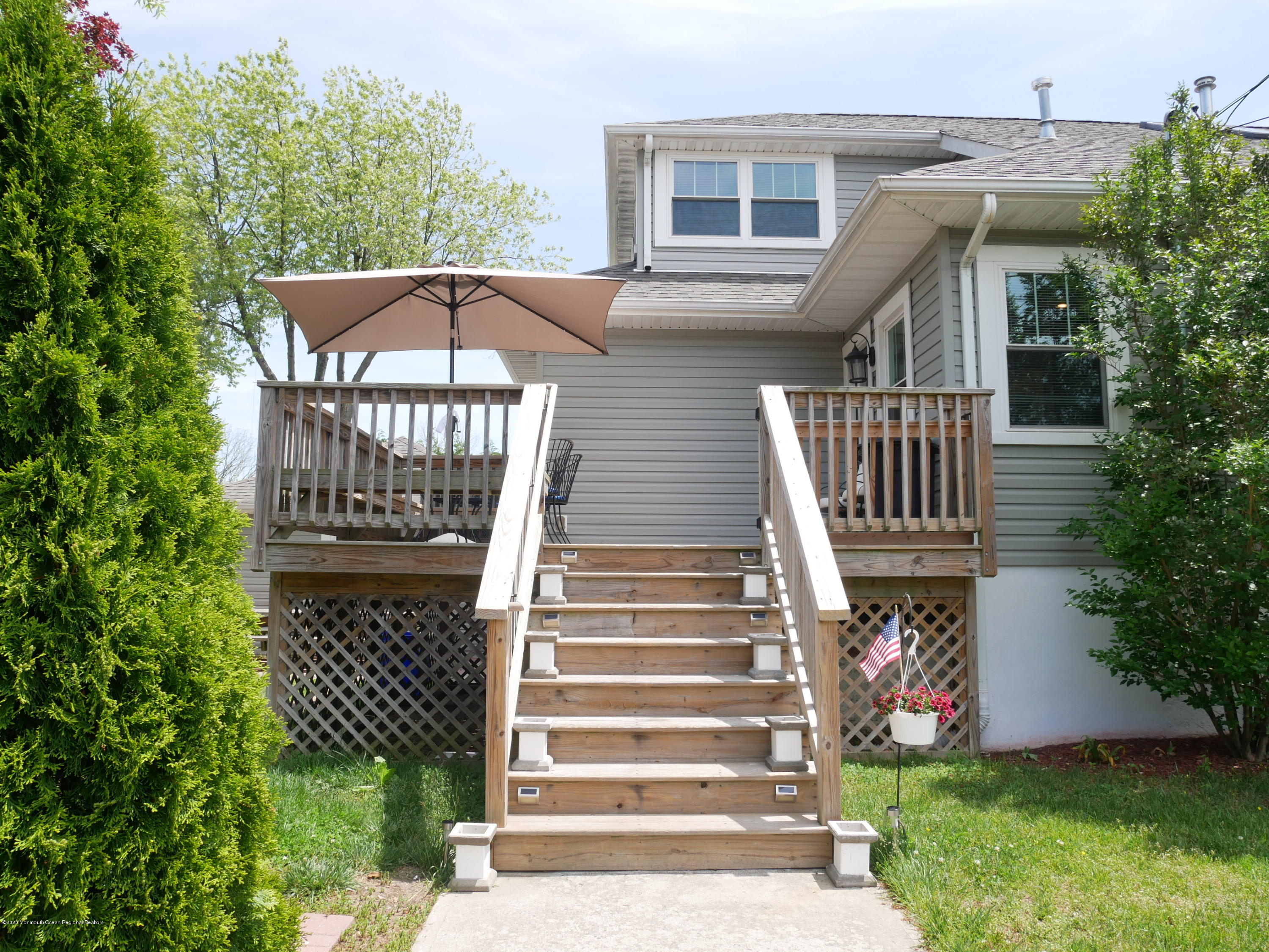 319 Arnold Avenue Point Pleasant Beach, NJ 08742 - Photo 30 of 34 a view of a house with a small yard and wooden fence