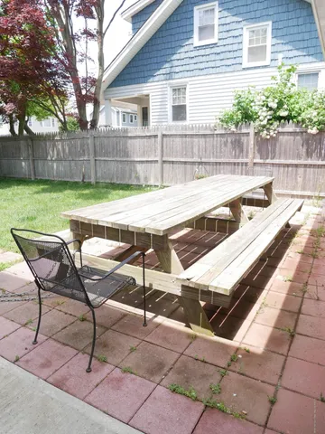 a view of a chairs and table in the backyard