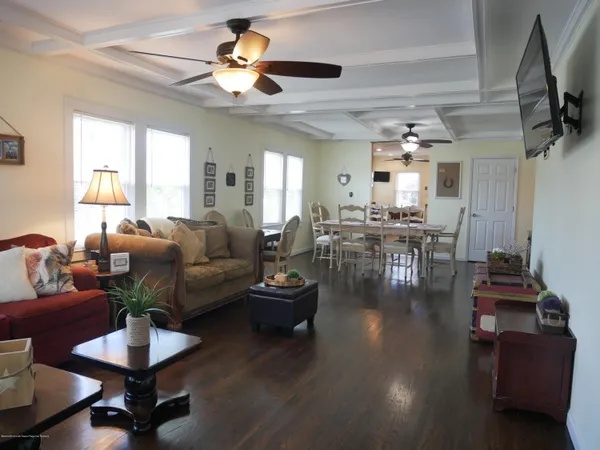 a living room with furniture and a chandelier
