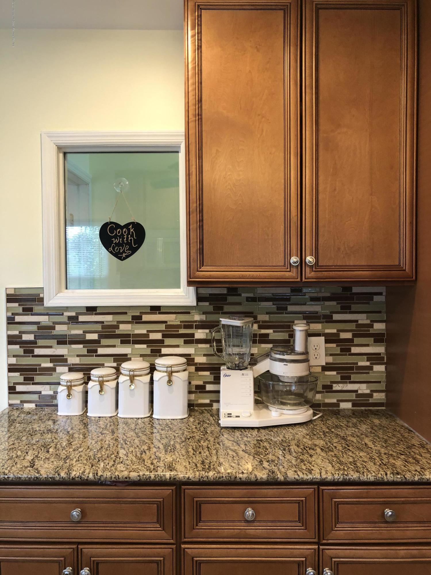 319 Arnold Avenue Point Pleasant Beach, NJ 08742 - Photo 9 of 34 a bathroom with mirror sink and vanity