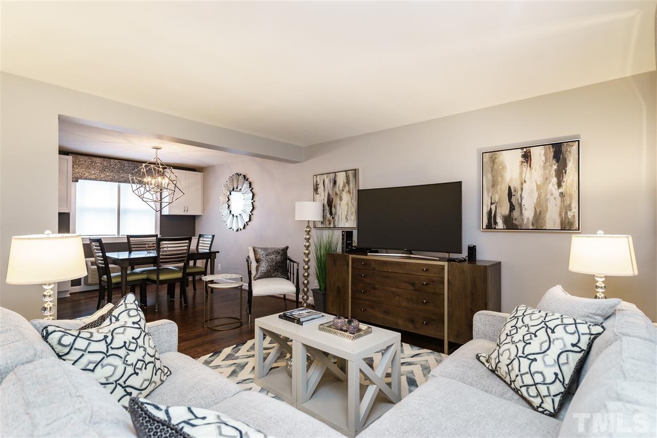 1641 Sutton Drive, Unit 3 Raleigh, NC 27605 - Photo 1 of 19 a living room with furniture a flat screen tv and wooden floor