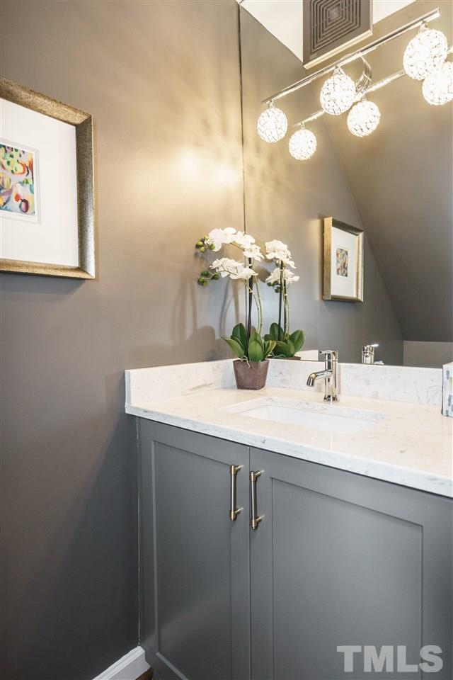 1641 Sutton Drive, Unit 3 Raleigh, NC 27605 - Photo 11 of 19 a bathroom with a sink and a mirror