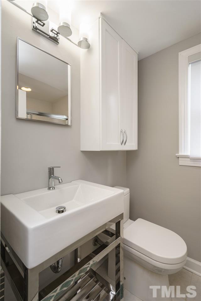 1641 Sutton Drive, Unit 3 Raleigh, NC 27605 - Photo 14 of 19 a bathroom with a sink a mirror and a toilet
