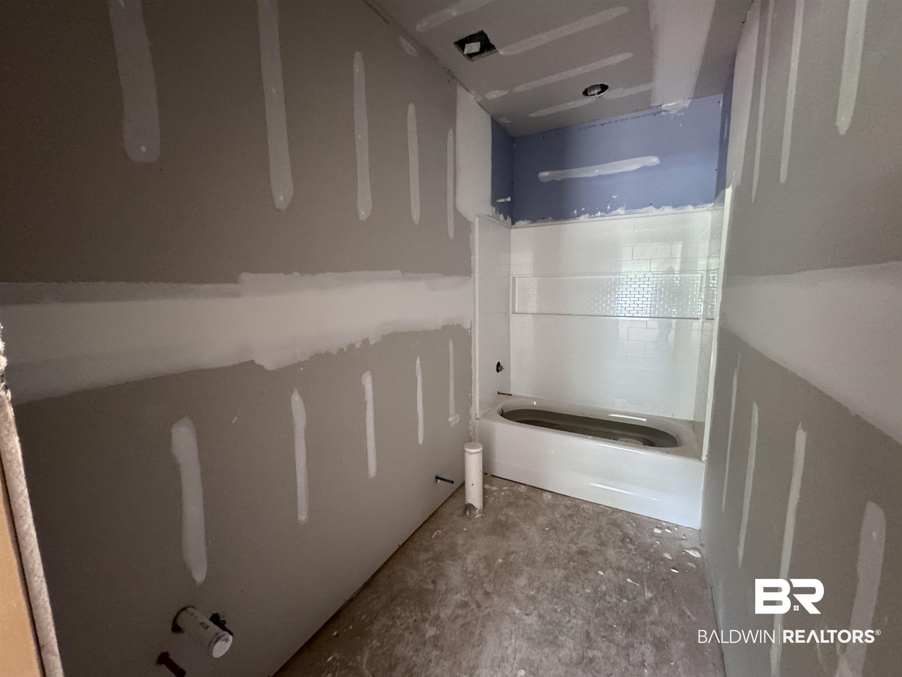 27355 Patch Pl Loop Daphne, AL 36526 - Photo 12 of 17 Bathroom under construction featuring a built-in bathtub with white subway tile surround and a decorative accent band