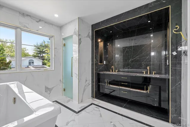 a bathroom with a bathtub and a shower