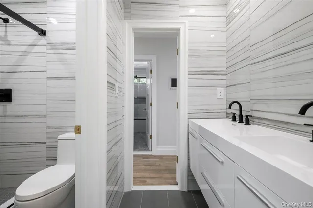 a bathroom with a sink a toilet and shower